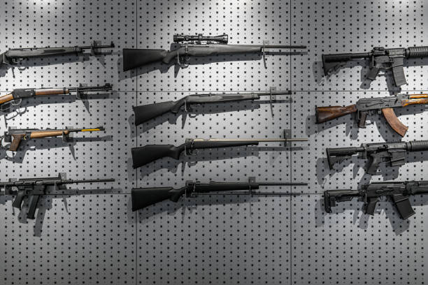 Rightful Liberty Arms | How to Buy a Gun Online with an FFL Transfer? Collection of rifles and carbines. Various firearms hang on special mounts on the wall. Weapon background.